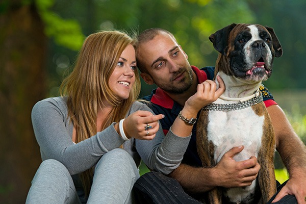 Couple Playing with Dog